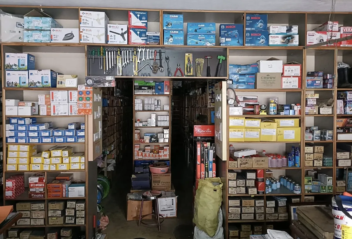 Shelves inside the shop stocked with boxed Bajaj, Crompton, Cumi, Bosch, Makita and Finolex products